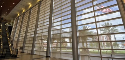 Automated window coverings in office help save electricity.