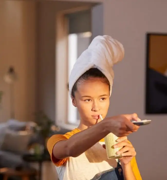 Women with cordless window blind remote control